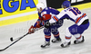 Jan Mursak (no.13) of Slovenia (L) and Kevin Phillips (no.18) of Great Britain (R) during ice hockey match of IIHF Ice hockey World championships Division I, group B between Great Britain and Slovenia. Match between Great Britain and Slovenia of IIHF Ice hockey World championships Division I, group B was held on Tuesday, 20th of April 2010 in Ljubljana, Slovenia.
