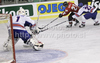 Janos Vas (no.21) of Hungary (M) is trying to get next to Danny Meyers (no.23) of Great Britain (R), while goalie Stephen Murphy (no.1) of Great Britain (L) observing action during ice hockey match of IIHF Ice hockey World championships Division I, group B between Great Britain and Hungary. Match between Great Britain and Hungary of IIHF Ice hockey World championships Division I, group B was held on Wednesday, 21st of April 2010 in Ljubljana, Slovenia.
