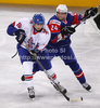 Robert Farmer (no.10) of Great Britain (L) and Rok Ticar (no.24) of Slovenia (R) during match of IIHF Ice hockey World championship Division 1 Group A between Slovenia and Great Britain. Match between Slovenia and Great Britain of IIHF Ice hockey World championship Division 1 Group A was held in Stozice Arena in Ljubljana, Slovenia, on Sunday, 15th of April 2012.
