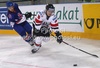 Stefan Geier (no.19) of Austria (R) and Stevie Lee (no.4) of Great Britain (L) during match of IIHF Ice hockey World championship Division 1 Group A between Austria and Great Britain. Match between Austria and Great Britain of IIHF Ice hockey World championship Division 1 Group A was held in Stozice Arena in Ljubljana, Slovenia, on Monday, 16th of April 2012.
