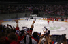 Spectators celebrating goal of Slovenian team during match of IIHF Ice hockey World championship Division 1 Group A between Slovenia and Hungary. Match between Slovenia and Hungary of IIHF Ice hockey World championship Division 1 Group A was held in Stozice Arena in Ljubljana, Slovenia, on Wednesday, 18th of April 2012.
