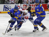 Ziga Jeglic (no.8) of Slovenia (M) between Vitaliy Liutkevyich (no.28) of Ukraine  (L) and Oleksandr Pobiedonostsev (no.14) of Ukraine  (R) during match of IIHF Ice hockey World championship Division 1 Group A between Slovenia and Ukrain. Match between Slovenia and Ukrain of IIHF Ice hockey World championship Division 1 Group A was held in Stozice Arena in Ljubljana, Slovenia, on Thursday, 19th of April 2012.
