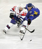 Tomaz Razingar (no.9) of Slovenia and Oleksandr Materukhin (no.17) of Ukraine during match of IIHF Ice hockey World championship Division 1 Group A between Slovenia and Ukrain. Match between Slovenia and Ukrain of IIHF Ice hockey World championship Division 1 Group A was held in Stozice Arena in Ljubljana, Slovenia, on Thursday, 19th of April 2012.
