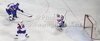Goalie Robert Kristan (no.30) of Slovenia (R) saving his goal from shot of Oleksandr Iakovenko (no.12) of Ukraine  (L) during match of IIHF Ice hockey World championship Division 1 Group A between Slovenia and Ukrain. Match between Slovenia and Ukrain of IIHF Ice hockey World championship Division 1 Group A was held in Stozice Arena in Ljubljana, Slovenia, on Thursday, 19th of April 2012.
