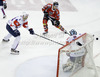 Manuel Latusa (no.15) of Austria (M) shooting between Sabahudin Kovacevic (no.86) of Slovenia (L) while goalie Andrej Hocevar (no.1) of Slovenia saves during match of EIHC Ice hockey tournament between Slovenia and Austria. Match between Slovenia and Austria was held in Ljubljana Hala Tivoli arena, Slovenia, on Saturday, 10th of November 2012.

