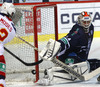 Steve Moses (no.12) of Jokerit Helsinki, Goalie Cal Heeter (no.34) of KHL Medvescak during match of fore last round of regular season Ice hockey KHL, Kontinental Hockey League, between KHL Medvescak Zagreb and Jokerit Helsinki. KHL ice hokey match between KHL Medvescak Zagreb, Croatia, and Jokerit Helsinki, Finland, was played in Dom Sportova Arena in Zagreb, Croatia, on Sunday, 22nd of February 2015.
