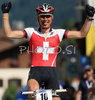 Urs Huber of Switzerland reacts as he passes the finish line at the 2008 UCI Mountain Bike Marathon World Championships at Villabassa, Italy, Saturday, July 5, 2008.
