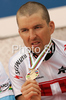 Third placed Christoph Sauser of Switzerland celebrate his medal won in UCI Mountain bike Marathon World Championships race in Graz - Stattegg, Austria. 104km long men race was held in Graz - Stattegg, Austria, on 23rd of August 2009.
