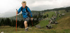 Nordic walking on hills around Zajamniki mountain pasture near Bohinj, Slovenia. Zajamniki mountain pasture is located 1234m above sea level, just few kilometers north of Bohinj Lake, Slovenia. Approximately 80 cottages, before used as herdsman houses, are nowadays mainly used as summer cottages, and are spread almost in straight line through Zajamniki pasture. View Julian alps in background, they create one of most magnificent views in mountains of north west Slovenia.

