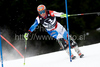 Didier Cuche (SUI) attacks a control gate while competing in the mens Hahnenkamm slalom race part of the  70th Hahnenkamm Rennen race weekend, which is a fixture on the 2009/10 Audi FIS Alpine Skiing World Cup. Slalom race of men Audi FIS Alpine skiing World cup was held in Kitzbuhel, Austria, on 24th of January 2010.
