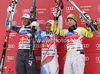 Winner Beat Feuz of Switzerland (middle), second placed Bode Miller of USA (left) and third placed Kjetil Jansrud of Norway (right) at the flower ceremony of Men Super-G race of Audi FIS alpine skiing World Cup in Val Gardena, Italy. Super-G race of Men Audi FIS Alpine skiing World Cup 2011 / 2012, was held on Friday, 16th of December 2011, on Saslong course in Val Gardena, Italy. 

