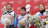 Winner Beat Feuz of Switzerland (middle), second placed Bode Miller of USA (left) and third placed Kjetil Jansrud of Norway (right) at the flower ceremony of Men Super-G race of Audi FIS alpine skiing World Cup in Val Gardena, Italy. Super-G race of Men Audi FIS Alpine skiing World Cup 2011 / 2012, was held on Friday, 16th of December 2011, on Saslong course in Val Gardena, Italy. 

