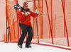 Finnish coach Mario Hani walking down the course with Tanja Poutiainen skis and poles after she crashed in first run of women giant slalom race of FIS Alpine skiing World Cup in Ofterschwang, Germany. Women giant slalom race of FIS Alpine skiing World Cup in Ofterschwang, Germany, was held on Saturday, 9th of March 2013.
