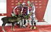 Winner Henrik Kistoffersen of Norway with Marcel Hirscher of Austria (L) and Felix Neureuther of Germany (R) with Kristoffersens prize reindeer which he named Lars celebrate on Podium of mens Slalom of FIS ski alpine world cup at the Levi Black in  Levi, Finland on 2014/11/16.
