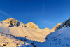 Sun is rising over mountains above Ljubelj road pass near Trzic, Slovenia, on early morning of 17th of December 2020. Sunrise is seen from slopes of Vrtaca mountain during ski mountaineering tour.