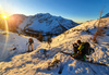 Sun is rising over mountains above Ljubelj road pass near Trzic, Slovenia, on early morning of 17th of December 2020, while ski mountaineers are climbing toward their goal. Sunrise is seen from slopes of Vrtaca mountain during ski mountaineering tour.