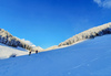 Ski touring in mountains above Jesenice, Slovenia, on windy but sunny 26th of December 2020. After 2 days of snowing mountains woke up in sunny day with 30cm of fresh snow, but also strong winds, which was drifting snow around.