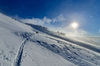 Ski touring in mountains above Jesenice, Slovenia, on windy but sunny 26th of December 2020. After 2 days of snowing mountains woke up in sunny day with 30cm of fresh snow, but also strong winds, which was drifting snow around.