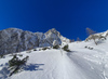 Winter in mountains above Vrata valley near Mojstrana, Slovenia. Even though temperatures in valley are spring like already, winter higher up in mountains is still present and offers plenty of joy for ski tourers and mountaineers.