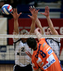 Mitja Gasparini of ACH Volley Bled (M) spikes over Roberto Carlos Brito da Purificacao of OK Salonit Anhovo (L) and Andrej Kovacic of OK Salonit Anhovo (R) during first match of Slovenian National Championships finals between ACH Volley, Bled, Slovenia and OK Salonit Anhovo, Slovenia. Match was won by ACH Volley Bled who defeated OK Salonit Anhovo with 3:0. Match was played in Radovljica, Slovenia on 12th of April 2008.
