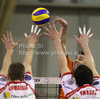 Andrej Flajs (no.1) of ACH Volley (M) spikes over Matias Raymaekers (no.2) of Lube Banca Marche Macerata (L) and Igor Omrcen (no.15) of Lube Banca Marche Macerata (R) during match of CEV Indesit Volleyball Champions League between ACH Volley, Bled, Slovenia and Lube Banca Marche Macerata, 	Macerata, Italy. Match of CEV Indesit Volleyball Champions League between ACH Volley and Lube Banca Marche Macerata was played in Tivoli Arena, Ljubljana, Slovenia, on Wednesday, 10th of February 2010.
