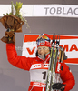 Winner Marit Bjoergen of Norway celebrates her medal won in women sprint free style race of Tour de Ski race of FIS cross country skiing World cup race in Toblach-Dobbiaco, Italy. Women sprint race, stage 6 of Tour de Ski and FIS cross country skiing World cup was held on Toblach-Dobbiaco, Italy, on Wednesday, 4th of January 2012.
